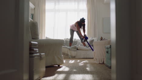 happy-young-woman-dancing-at-home-using-vacuum-cleaner-having-fun-dance-cleaning-house-on-weekend-celebrating-success