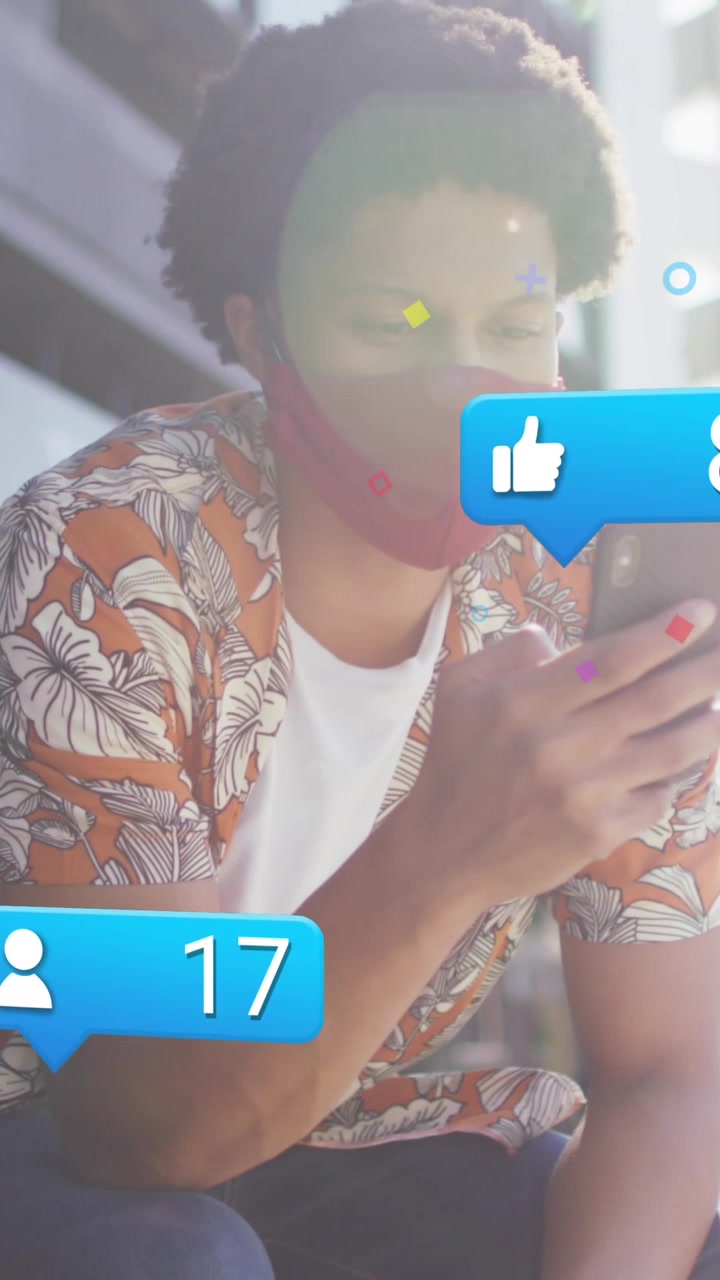 Animation of media icons over african american man using smartphone