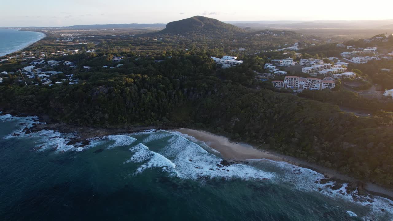 Aerial View of Coastline with Mountain and Beach