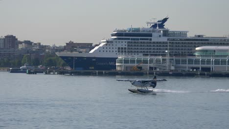 seaplane taking off with cruise ship in background tracking