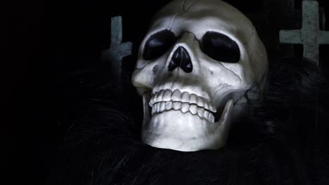 Skull-with-crosses-on-dark-background-zoom-out-shot