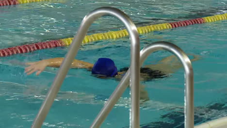 woman swimming in indoor pool