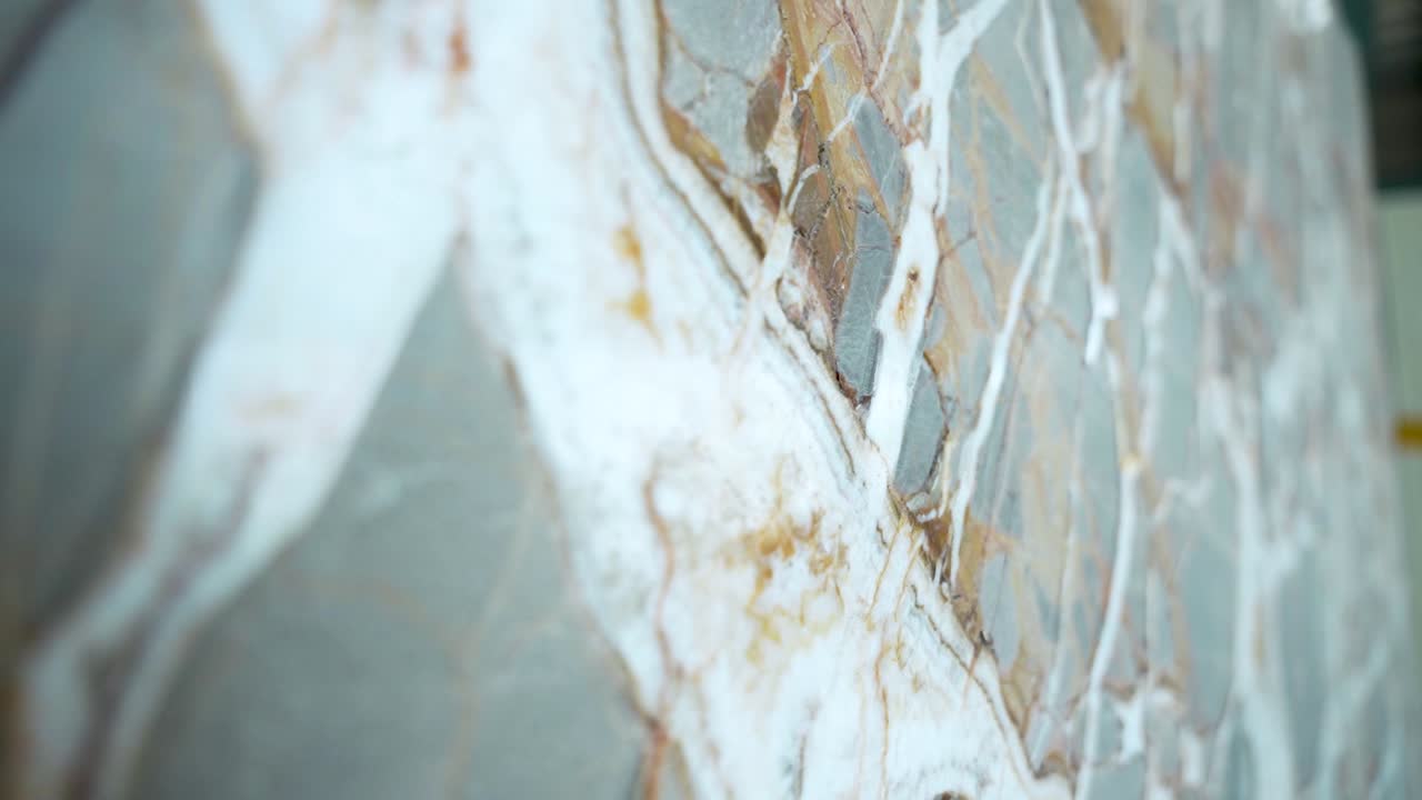 Close-up of natural marble slab with unique veins and patterns in brown, white, and gray. High-quality polished stone surface, perfect for interiors, tiles, countertops, and luxury design visuals