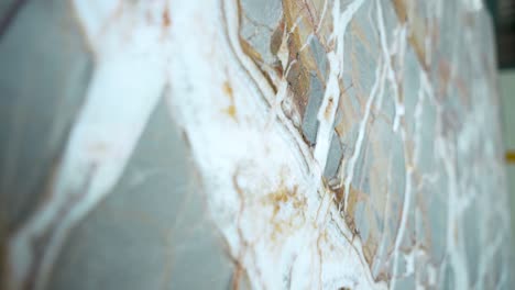 close-up of natural marble slab with unique veins and patterns in brown, white, and gray. high-quality polished stone surface, perfect for interiors, tiles, countertops, and luxury design visuals