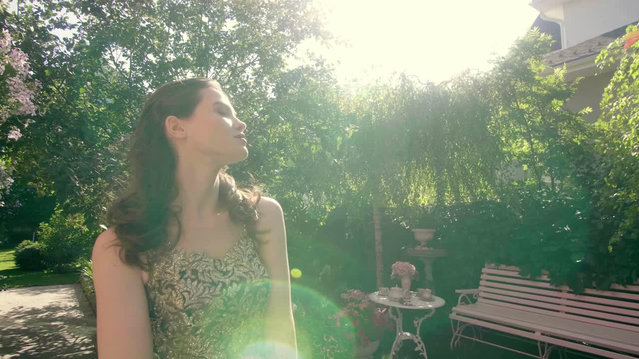 Woman in a Golden Dress in a Garden