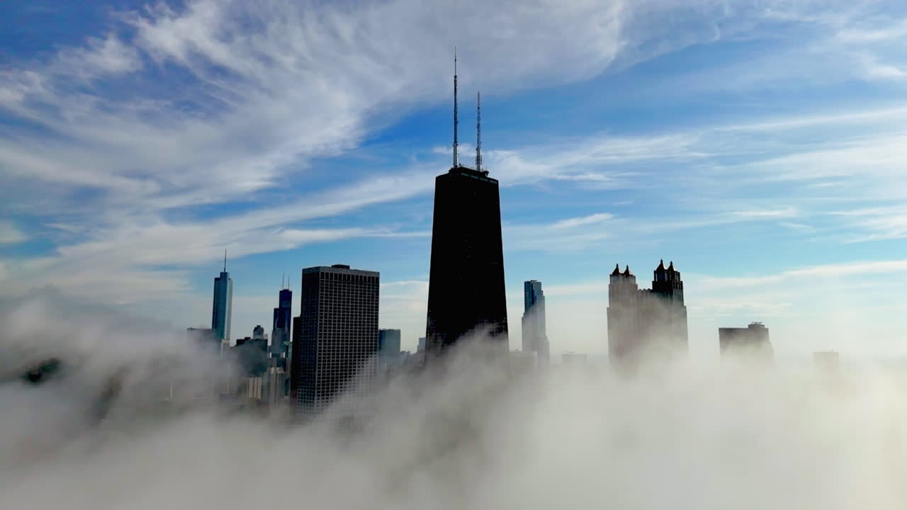 Drone flying in front of low hanging clouds at the Chicago Streeterville skyline