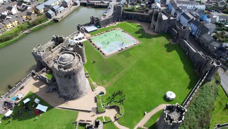 groups of people visiting pembroke castle, wales