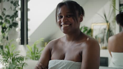 Portrait-of-young-smiling-African-American-woman-in-the-bathroom.