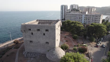 4k drone fly-by over the ancient medieval defensive square stone tower of oropesa del mar by the mediterranean sea, spain