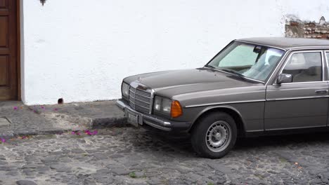 an old mercedes benz parked in the streets of antigua, guatemala