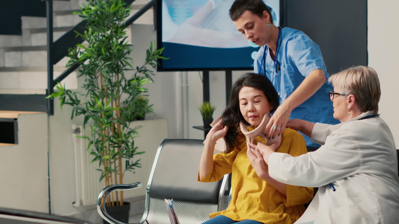 Medical staff adjusting cervical collar on patient
