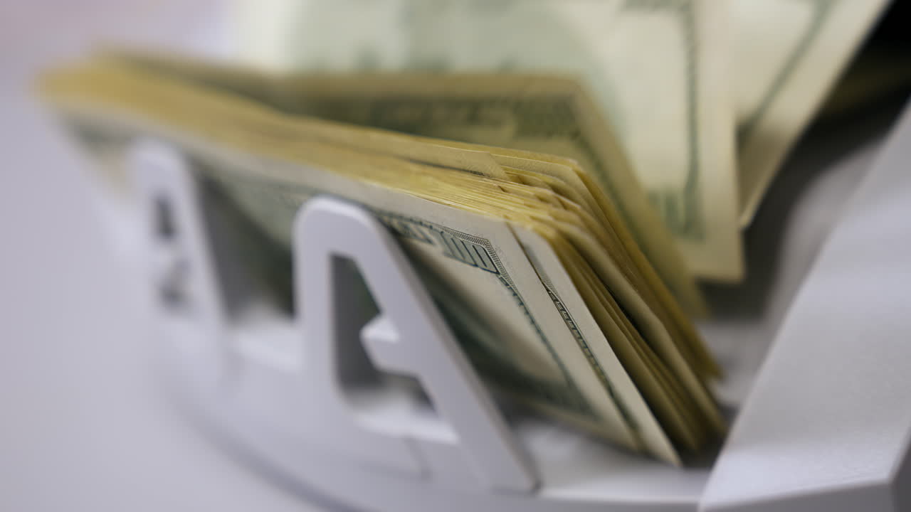 Money counting machine. Banknote counter are counting hundred dollar bills. Close-up