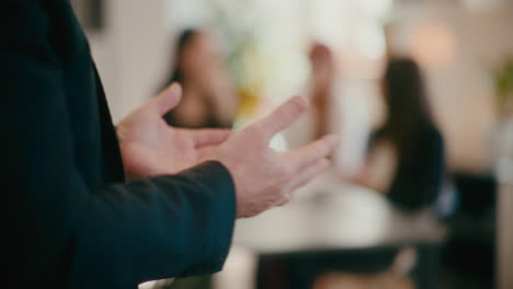 hands of manager gesturing in office.