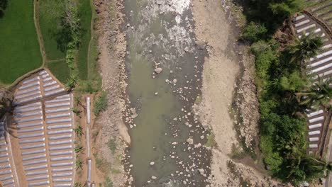 top down view of small water stream on the big rocky river during dry season