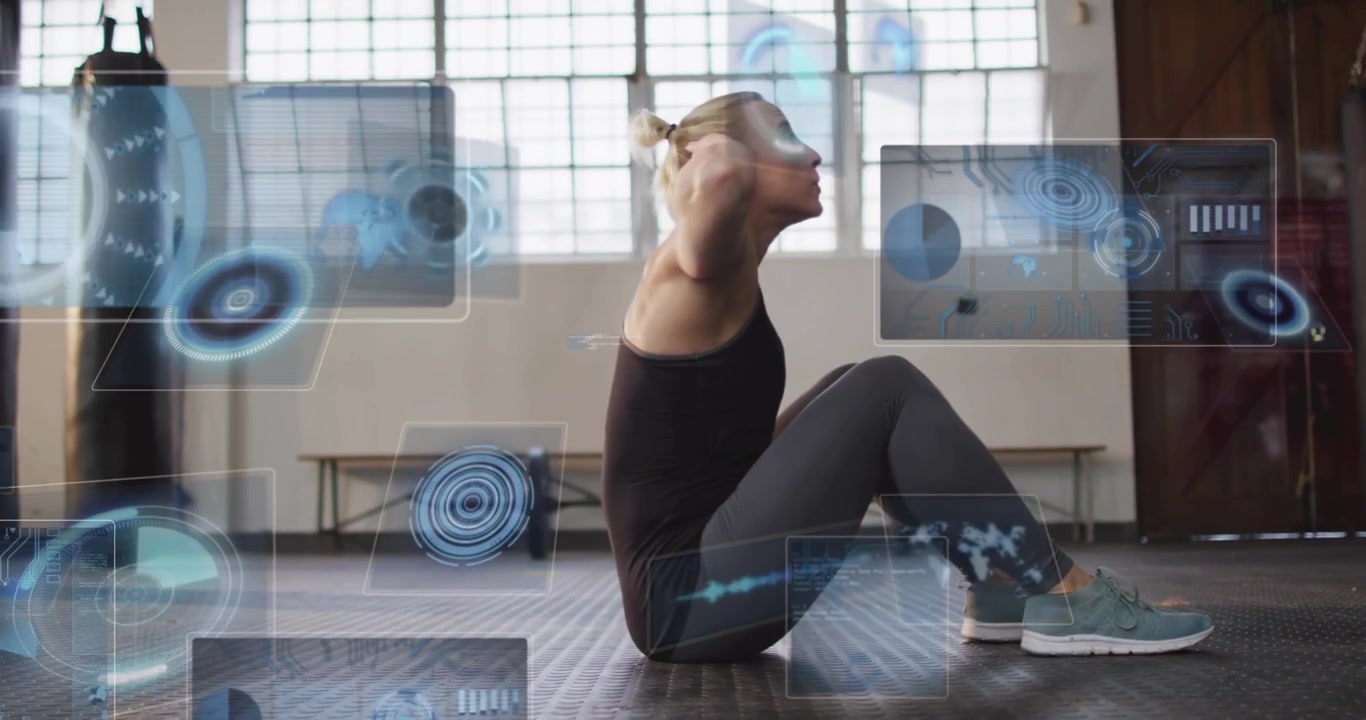 Woman initiating sit-ups on gym floor, generating holographic panels tracking workout metrics
