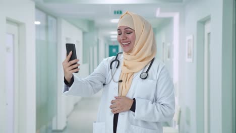 happy muslim doctor talking on video call