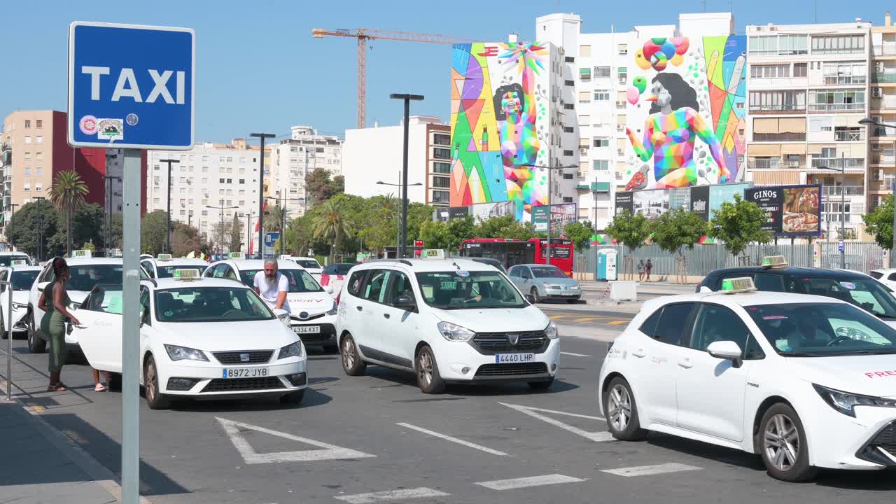 Taxi Rank in a Sunny City with Colorful Mural