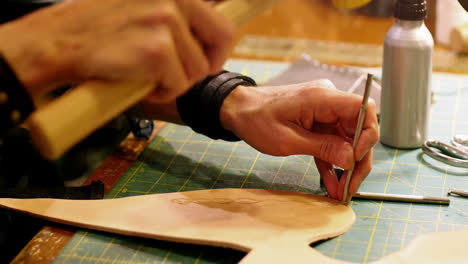 Close-up-of-craftswoman-nailing-leather