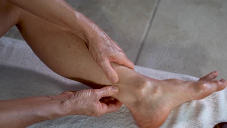 Extreme-closeup-of-mature-woman-using-her-fist-to-massage-the-sole-of-her-foot