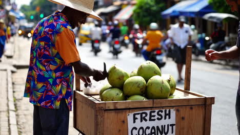 street vendor selling fresh coconuts in a busy city