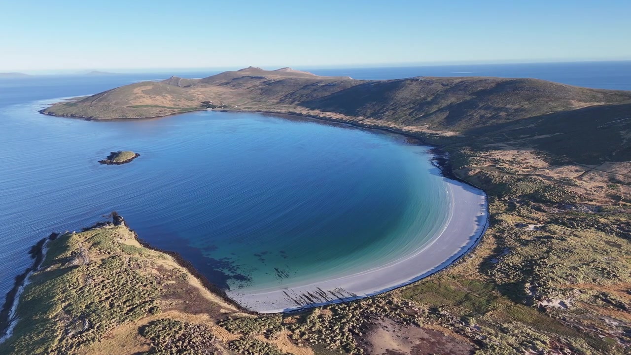 Aerial view of Carcass Island with rugged coastline and remote island landscape in the Falkland Islands, drone footage