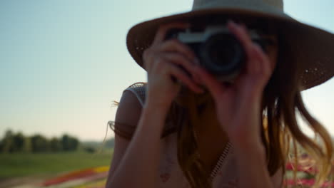 professional woman photographer making photo in beautiful garden with flowers.