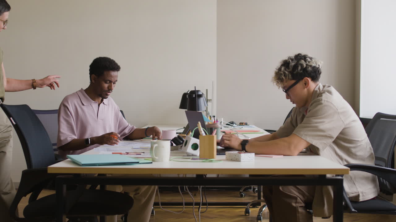 People working and collaborating at desks in a modern office