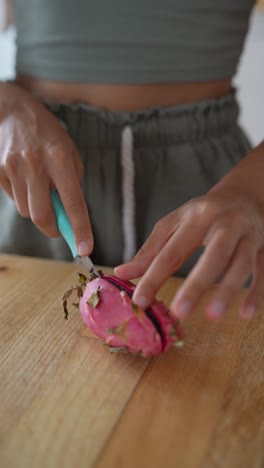 woman cutting dragon fruit