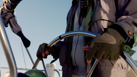 closeup, steering ship and hands on a wheel