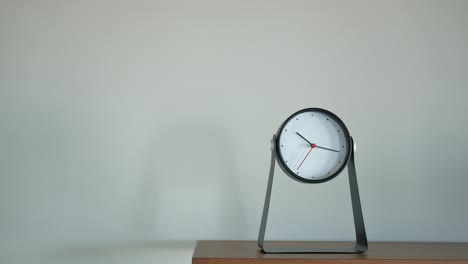 modern table clock on wooden surface