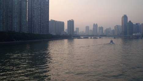 view of guangzhou pearl river with river tour boats sailing along the river and numerous office building on the side of the river