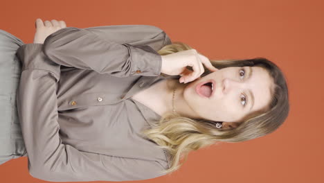 Vertical-video-of-Thoughtful-young-woman-towards-camera-comes-up-with-an-idea.