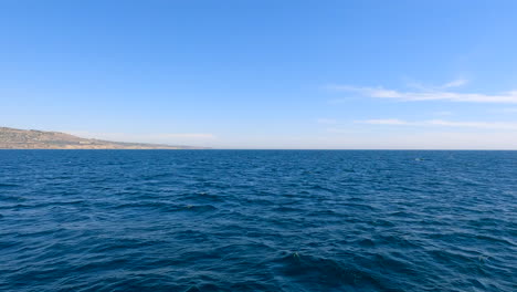 flying fast just over the surface of the pacific ocean off the coast of southern california