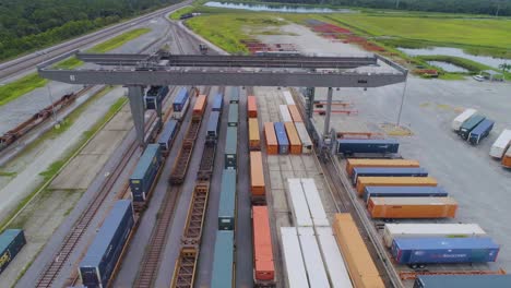 4k drone video of trains and trucks at csx intermodal train yard in winter haven, fl