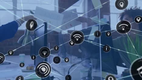 animation of network of digital icons over biracial man passing a socument to asian woman at office