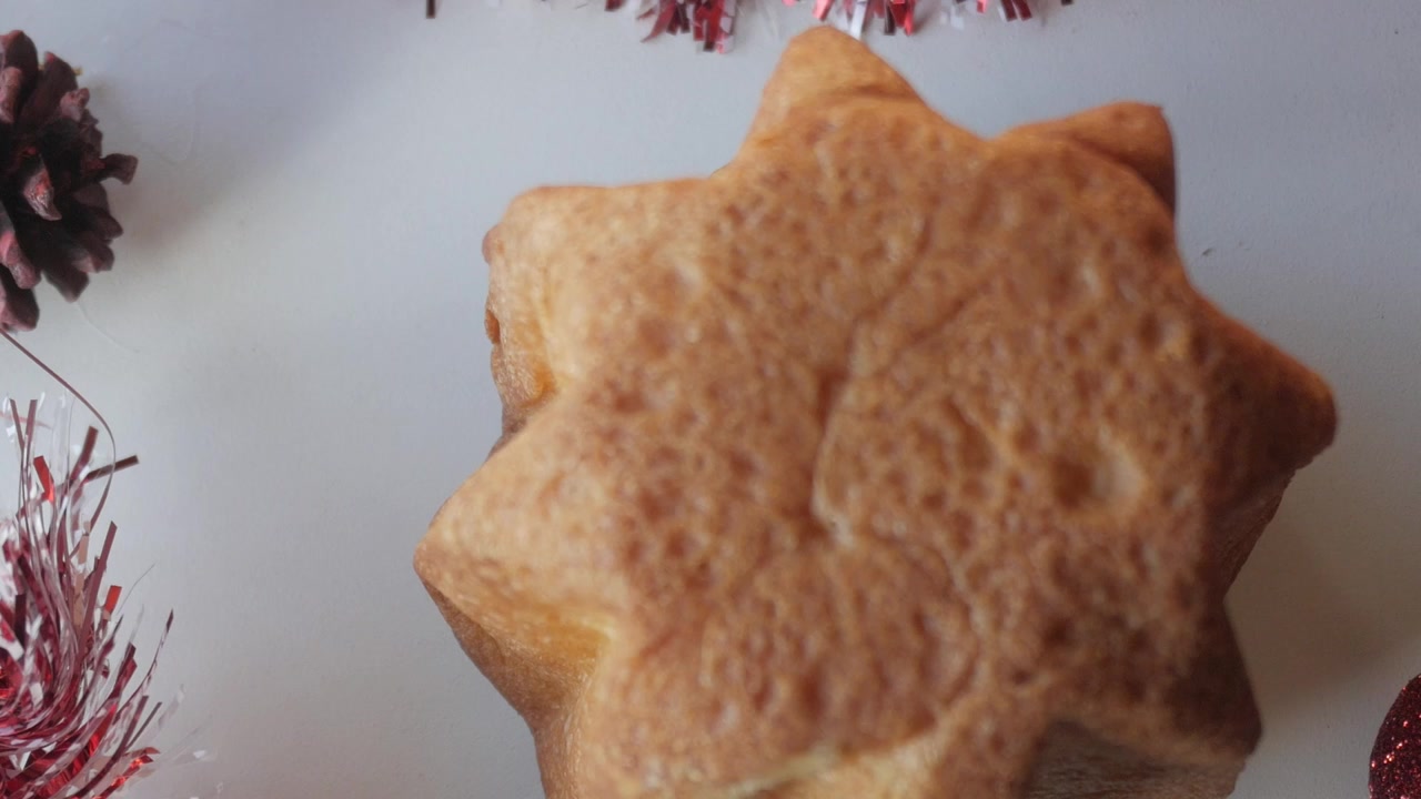 Panettone with festive pine cones and tinsel, capturing Christmas cheer