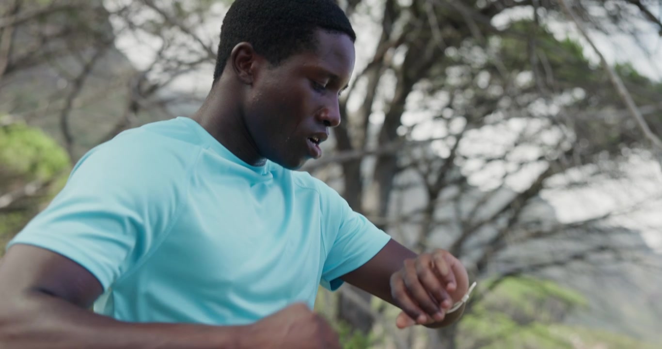 Sweaty Runner Checking Smartwatch After Workout in Nature