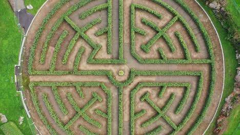 high angle aerial vertical view of a garden labyrinth made of perfect cut bushes