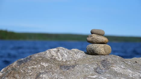 three rocks piled on each other. peaceful lake scenery