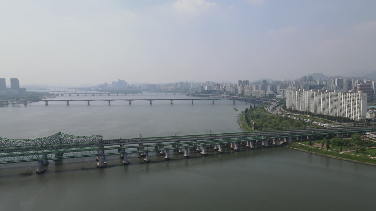 Aerial shot flying over Han River with Seoul city skyline, South Korea