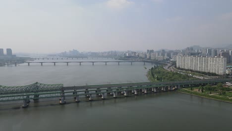 aerial shot flying over han river with seoul city skyline, south korea