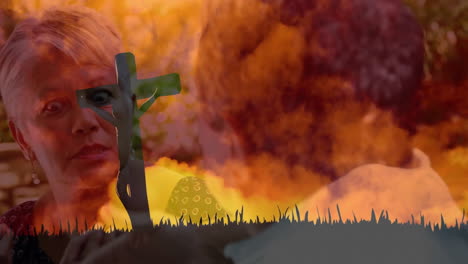 fiery explosion background with silhouette of cross over elderly woman