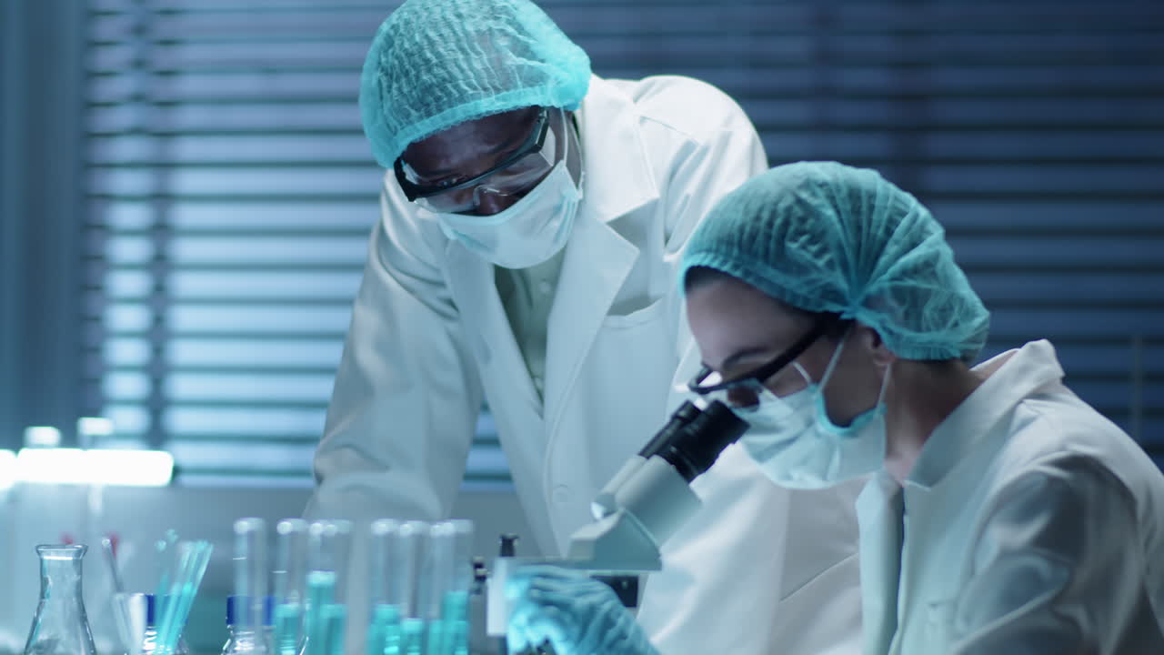 Scientists in Protective Uniform Working in Lab