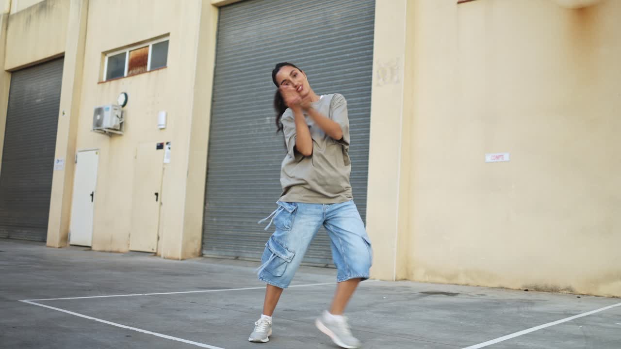 Young Woman Performing Energetic Hip Hop Dance in Urban Setting