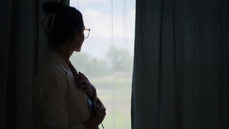 Silhouette-of-Businesswoman-Writing-in-Notebook-by-Window