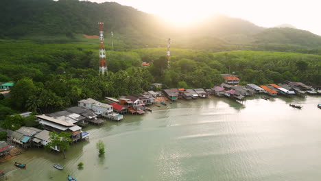 Calm-waves-push-in-as-golden-hour-light-spreads-on-old-town-over-Northern-Koh-Lanta-coast