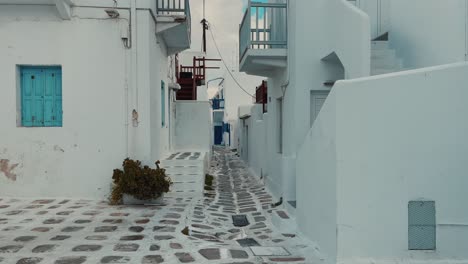 walking in mykonos town in greece - greek style buildings