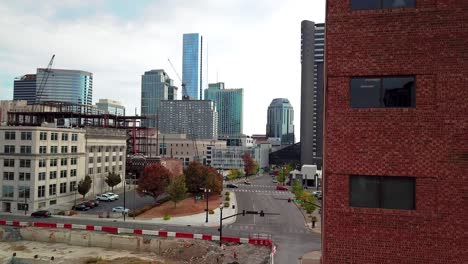 drone reveals downtown nashville from behind a building