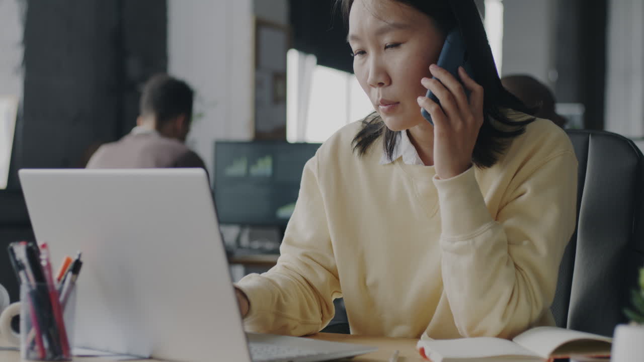 Woman on Phone Call in Modern Office