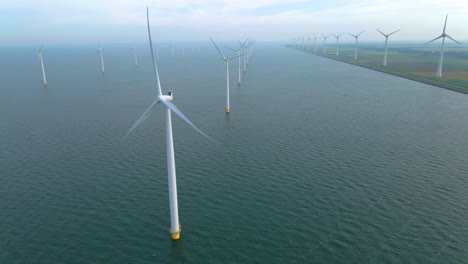 huge windmill turbines, offshore windmill farm in the ocean westermeerwind park , windmills isolated at sea on a beautiful bright day netherlands flevoland noordoostpolder